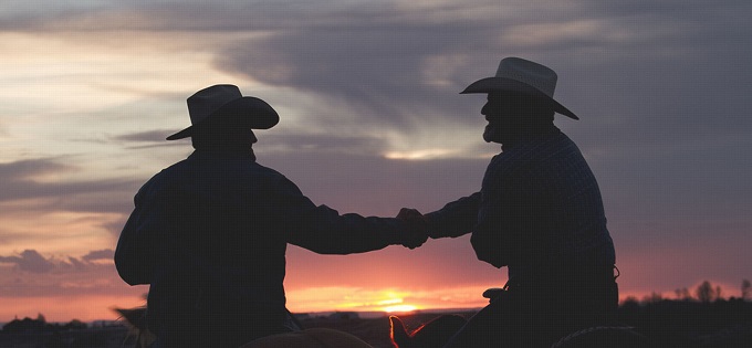 Cowboys shaking hands