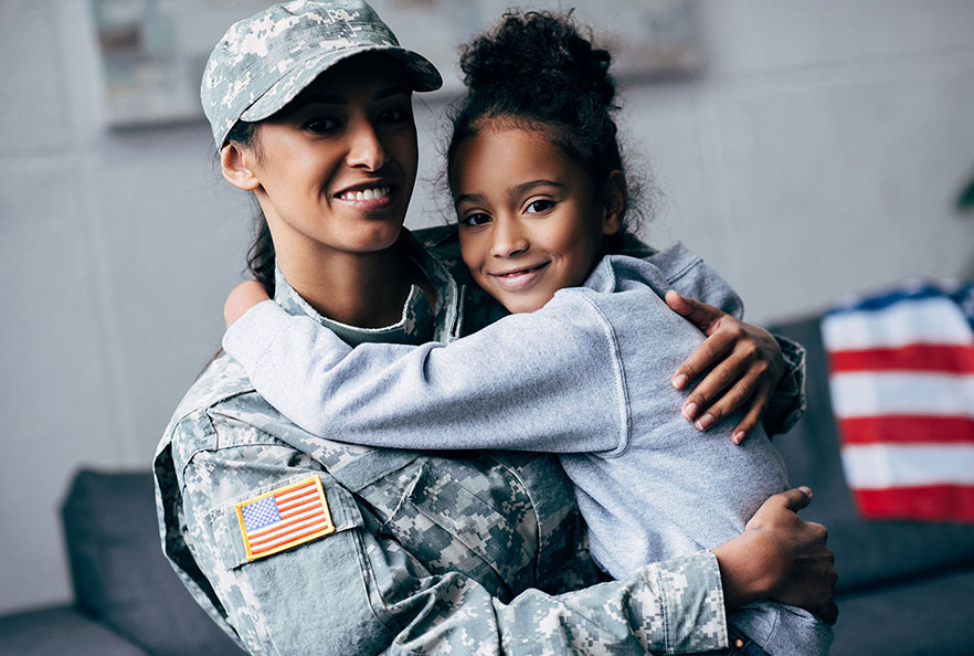 Female veteran holding her daughter 