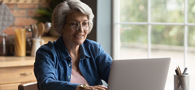 Older-Woman-Smiling-at-Laptop-680x315