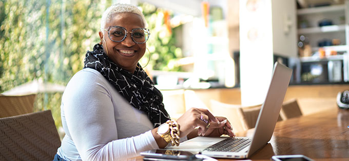 Smiling-Mature-Woman-at-Laptop-680x315