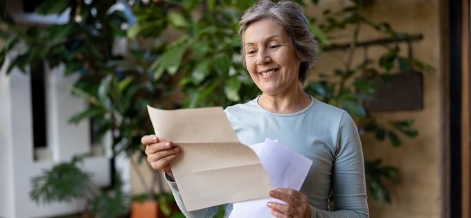 FAQ-Happy-Senior-Woman-Reading-a-Letter-680x315px