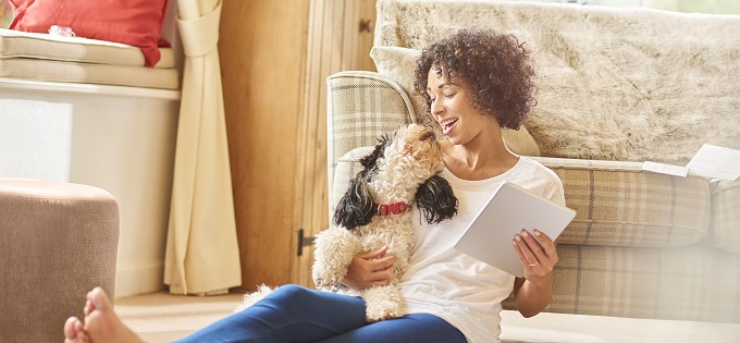 Article-Woman-Snuggles-Dog-While-Shopping-Online-680x315