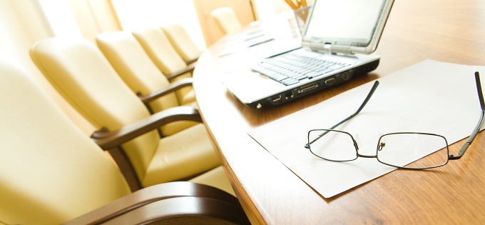 Board room with laptop and glasses