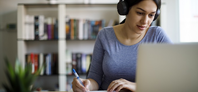 Young Woman Studies Laptop on Desk