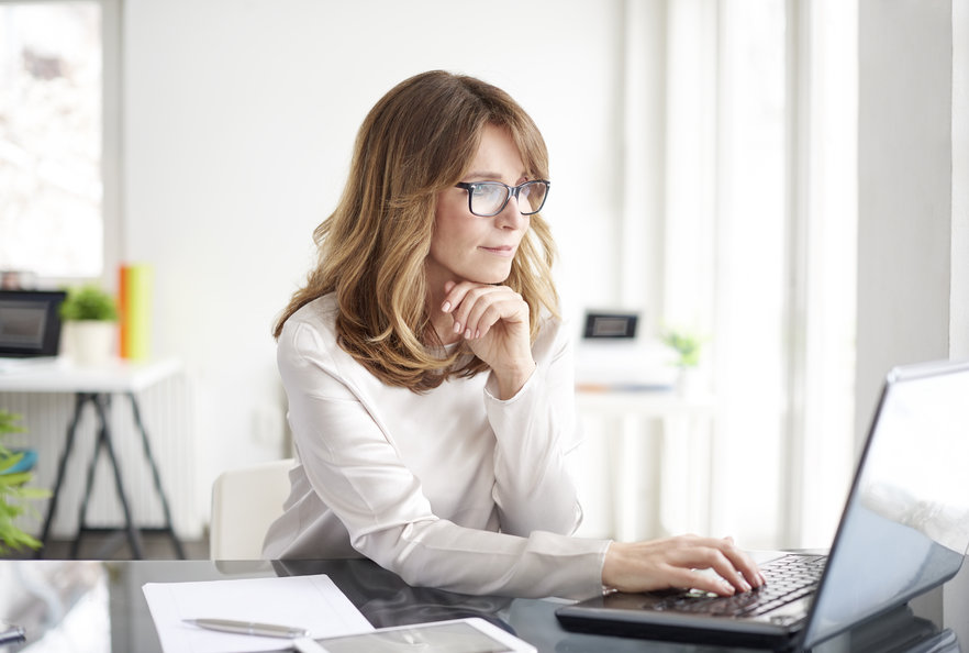 Woman typing in her laptop