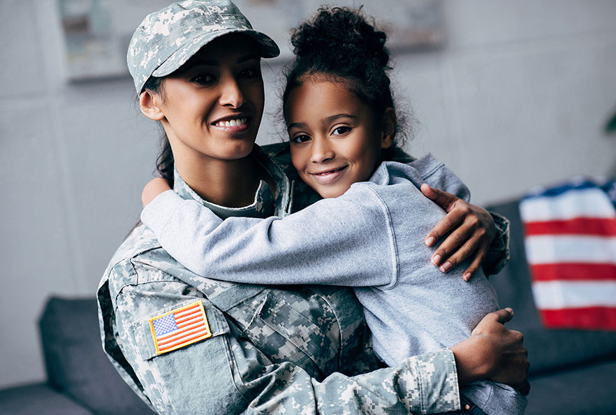 Female veteran holding her daughter