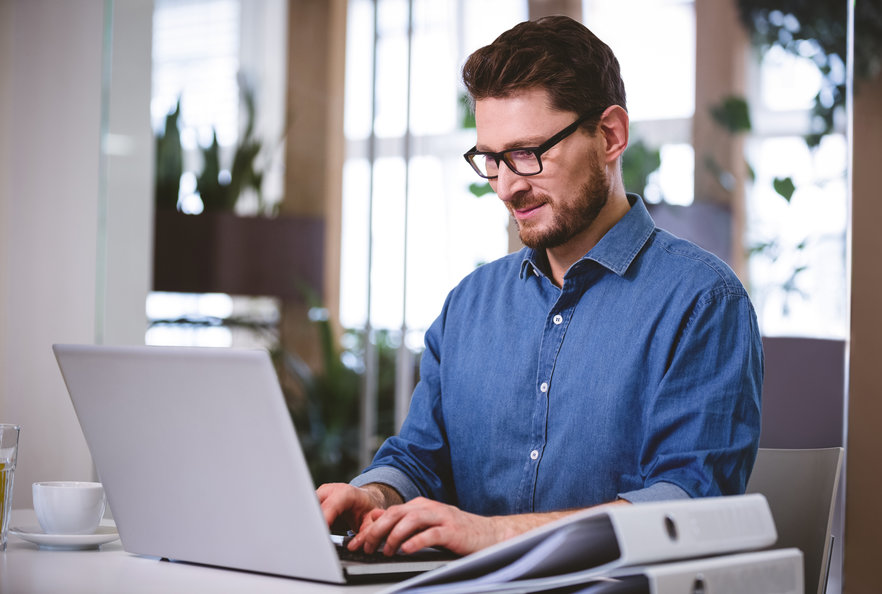 Young male typing in his laptop